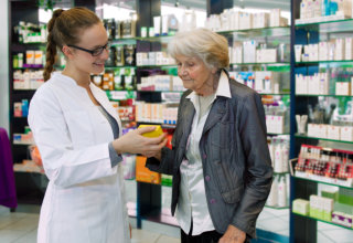 pharmacist assisting old woman
